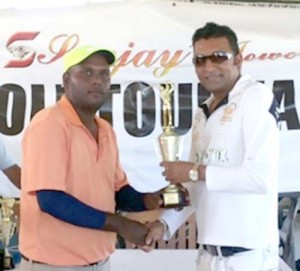 Last year’s winner Mahendra Bhagwandin receiving his prize from Mr. Sanjay Persaud  