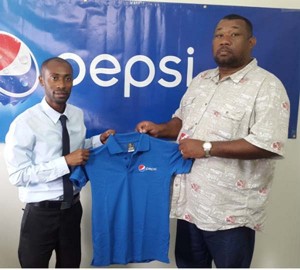 Hilbert Foster (right) receives a token Pepsi polo shirt from DDL’s Larry Wills.
