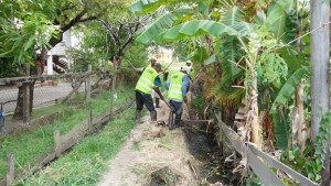 Community Enhancement Workers cleaning drains at Gapp Road, La Jalousie, West Coast Demerara