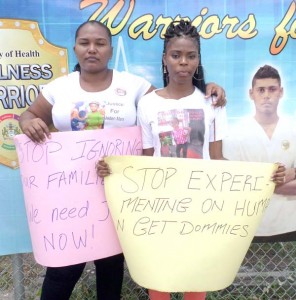 Natalie Caseley (left) and Althea Benons protesting outside the Health Ministry on Monday. 