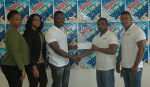 Supligen Brand Manager, Treion D’Anjou (second, right) hands over the sponsorship cheque to GABBFF President, Keavon Bess in the presence of other GABBFF Executives yesterday at the Park View Hotel, East Bank Demerara.