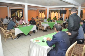 GFF TD Claude Bolton (standing backing camera) makes a point to representatives of the 8 Elite Clubs at Water Chris Hotel in the presence of other officials. 