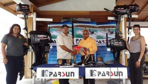 Crown Mining Supplies golf: Bhisham Persaud (second left), a Director of Crown Mining Supplies, presents the sponsorship package and trophies to Lusignan Golf Club President, David Mohamed, while two representatives of the entity proudly showcase the Parsun outboard engines. 