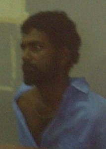 Arsonist Amir Bassalut in police custody.   