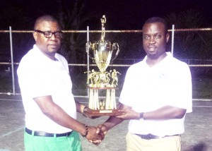  GABA Champion Presentation Former Junior National Player, Triston Tulloch (left), now based in New York, donates the Champions Trophy to GABA President, Andrew Hercules for the ongoing GABA ‘Kings of the Hard Court’ Basketball Championships. 