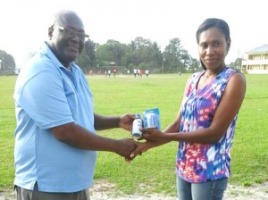 Mr. Ernest Joseph hands over some of the supplies to Ms. Michelle Jackman.