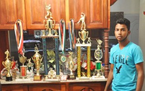 Captain Travis Persaud with some of his winning trophies.