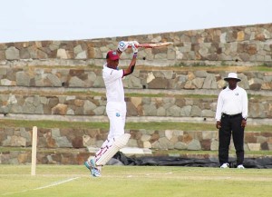 Umpire Nigel Duguid admires Royston Chase as he punches one for four in Antigua yesterday.  