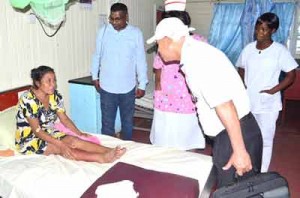 Minister of Public Health Dr. George Norton, accompanied by Chief Medical Officer (CMO) Dr. Shamdeo Persaud and staff of the Bartica Hospital visiting a patient
