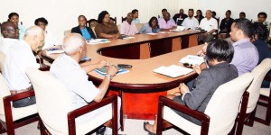 Minister of Communities, Ronald Bulkan (backing camera, at centre); Junior Minister of Communities, Keith Scott (to Bulkan’s immediate right), Permanent Secretary, Emil McGarrell (to Bulkan’s immediate left) at a meeting with senior officers of the Department of Housing. 