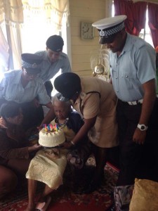Members of the Alberttown Police Station presenting Mrs Blackmore with a cake