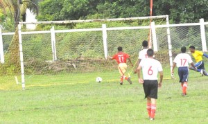 Ariel Chester finds the goal wide open as he scores one of Charity’s goals on Monday at the NOC ground, Essequibo.