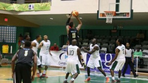 Defending Champs, Bahamas shoots over Guyana’s Gordon James in the paint during their game Tuesday night in Tortola, BVI. (www.caribbeanbaskebtall.com photo)