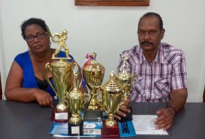 Berbice Cricket Board representatives Angela Haniff and Dhieranidranauth Somwaru pose with some of the trophies that will be up for grabs.