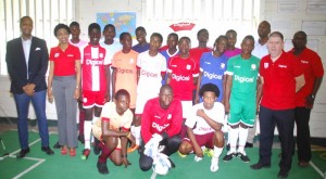 Digicel CEO Kevin Kelly (right standing), Marketing Executive Jacqueline James (2nd left), NC Chairman Clinton Urling (left), Director of Sport Christopher Jones (3rd right back row), Events & Sponsorship Manager Gavin Hope (right back row) and players pose for a photo op yesterday.