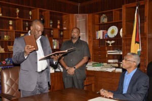 Mr. Joseph Harmon, Minister of State, takes the oath of office as Secretary to the Defence Board