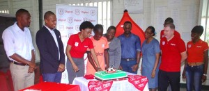 Marketing executive Jacqueline James (3rd left) cuts the cake to symbolise the start of the Digicel Schools Football Competition yesterday.