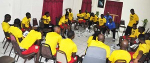 Players and officials of the Golden Jaguars engage in an interactive discussion session at their hotel in St Vincent after arriving yesterday.