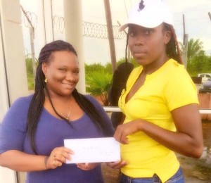 LABA Treasurer, Chantel Brookes (left) hands over the sponsorship to a national female player, Shanna Chester.