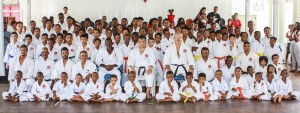 Ninth Dan Shuseki Shihan Frank Woon-A-Tai and other officials take time for a photo with the 95 students who were graded at the YMCA.
