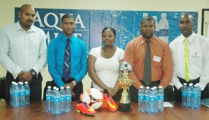 Officials from Banks DIH, including Aqua Mist Brand Manager, Errol Nelson (2nd left), Colours Boutique Sales Representative, Tameika Ferguson and Officials from Central Georgetown Police Youth Group, including Coordinator, Colin Haynes (right) launch the U-15 Football Tournament yesterday.