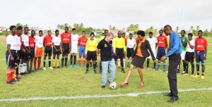 Digicel CEO Kevin Kelly, Head of Marketing Jacqueline James and Director of Sport Christopher Jones performing the ceremonial kick off signaling the start of the 2015 Digicel School’s Football Championships at the Leonora ground.