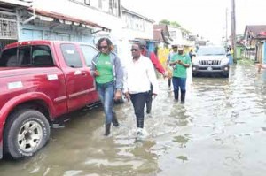 Minister within the Ministry of Public Infrastructure, Annette Ferguson (left), along with Minister within the Ministry of Social Protection, Simona Broomes, making visits to affected areas 