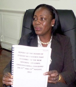 Minister within the Ministry of Education Nicolette Henry displays the report on the 2012 unrest at the New Opportunity Corps