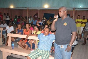 A resident of Kwakwani raising an issue at the meeting with the Minister.