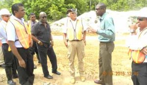  Minister of Public Infrastructure, David Patterson (second from right) speaking to CJIA officials  