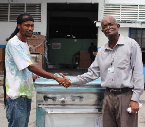 On the right Mr. Wayne Hamilton Public Relations Manager handing over stove to Mr. Richard Taylor, Chairman of the Festival City organization 