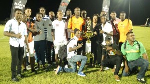 Slingerz FC receives the championship trophy from Ansa McAl’s PRO Ms. Darshanie Yussuf following their triumph against Ann’s Grove United in the 3rd Ansa McAl/Slingerz West Side Independence KO Cup. 