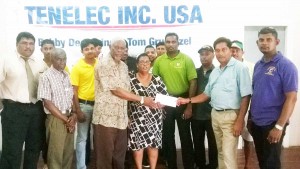 Bobby Deonarine of Tenelec Inc, Washington presents sponsorship cheque to Gervy Harry and Angela Haniff in the presence of other representatives of the sponsor, officials of BCB, representative of Regional Administration and cricketers who have participated in these competitions over the years. 
