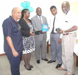  Mr Tota Mangar (extreme left) hands over the GITEP donation. In photo are: Principal of CPCE Ms Viola Rowe; Chief Education Officer, Olato Sam, a CPCE student, and Technical Adviser to the Minister of Education, Mr Vincent Alexander