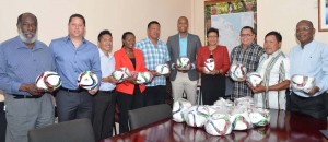 Government and GFF officials display the footballs at yesterday’s presentation.