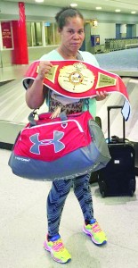 Gwendolyn O’Neil displays her freshly won UBF belt at the Miami Airport on her return from the fight.