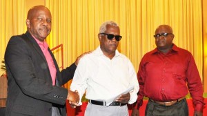 GPA representative Cecil Morris (centre) accepts the donation from Fitness Paradise’ Donald Sinclair. At right is GPA President, Wilton Spencer.      