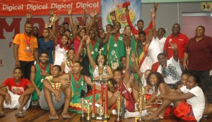 Digicel’s Events and Sponsorship Manager, Gavin Hope (standing, 2nd right) joins the victorious Kwakwani Girls’, U-16 and U-19 teams in celebration along with Coaches, Dave Causway (left) and Ann Gordon (right) Sunday night at the Cliff Anderson Sports Hall after collecting the prizes from winning the respective categories.