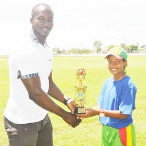 Player of the match Mandy Mangru collects her prize from national selector Rayon Griffith. 