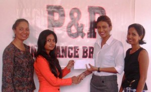 Pranita Seedath (left), P&P Accounting Officer presents cheque to GLTA Secretary Elizabeth Persaud, while Ms. Ahilya Panday (extreme left) of P & P and GLTA Treasurer Ileana Boodhoo looks on.