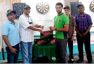 John Maikoo presents the prizes to the President of the Guyana Darts Association Mr. Jamwant Bhupan ; also in the picture are Lallchand Rambharose, Raphael DeSouza and Jamal Holligan.