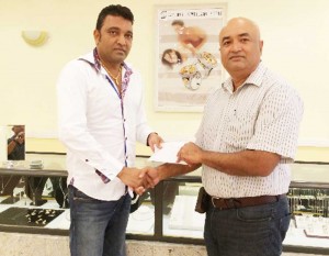 In picture at left, Mr Sanjay Persaud hands over sponsorship cheque to Club President Mr Oncar Ramroop. 