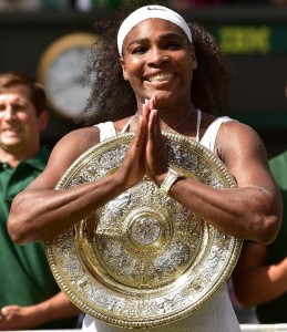 Serena Williams celebrates with the Venus Rosewater Dish, after her women’s singles final victory over Garbine Muguruza at the Wimbledon Championships in southwest London, on July 11, 2015 (AFP Photo/Leon Neal) 