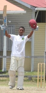 Tevin Imlach raises his bat after reaching his 100 at Eve Leary yesterday