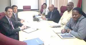 Minister Raphael Trotman (3rd right) and his team meeting with the Anadarko officials yesterday. 