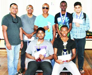 Anthony Drayton (seated right) with the other top performers following the presentation of the Caricom Day Rapid Chess tourney.