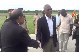 President David Granger shakes hands with PM Moses Nagamootoo at the Ogle Airport yesterday before departing for Barbados.