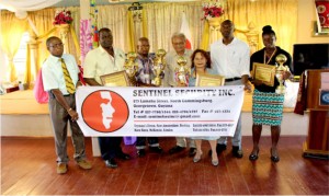 Minister of Education Dr. Rupert Roopnarine (4th right) and Director of Sports Christopher Jones (3rd right) pose with the Awardees and officials of Sentinel Security Inc.    