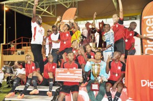 Minister within the Ministry of Education Nicolette Henry (3rd right standing) and Digicel CEO Kevin Kelly (next to her) pose with the winning trophy and the victorious Christainburg / Wismar School during the presentation ceremony yesterday. 