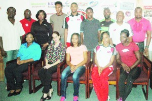  Athletes from Trinidad and Tobago, Jamaica and the Bahamas pose for a photo opportunity yesterday with representatives from Sponsors Digicel and Ansa McAl and the Coordinators at Olympic House, Kingston.